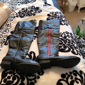 Knee high horse back ridding boots.